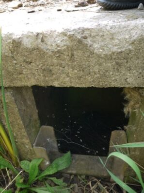 An open concrete structure that allows water to pass through.